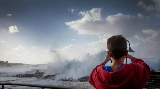 Una persona fotografía las olas rompiendo en la isla española de Tenerife, en el archipiélago de Canarias, el 29 de noviembre de 2014