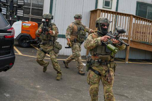 Agentes del ICE apuntan con armas a unos manifestantes concentrados ante un centro de detención temporal del organismo, el 6 de junio de 2026 en Newark (Nueva Jersey), al este de EEUU