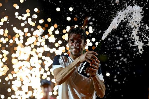 El tenista argentino Tomás Etcheverry celebra con champán su victoria sobre el chileno Alejandro Tabilo en la final del torneo de Río de Janeiro el 22 de febrero de 2026