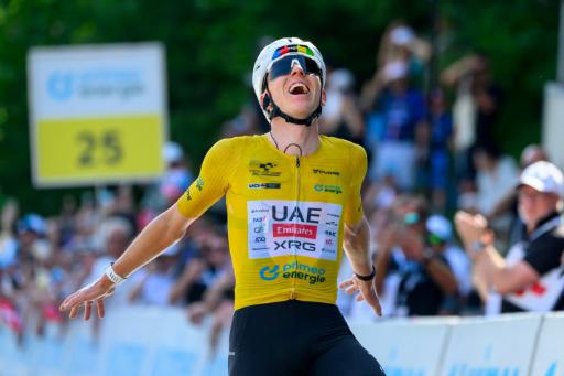 UAE Team Emirates - XRG team's Slovenian rider Tadej Pogacar celebrates as he crosses the finish line to win the fith and final stage of the Men's Tour of Switzerland (Tour de Suisse) cycling race, 150.7 km starting and finishing in Villars-sur-Ollon on June 21, 2026.