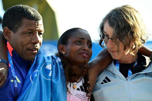La etíope Tigst Assefa (centro) es ayudada tras lesionarse en el maratón de Berlín, que ganó, el 27 de septiembre de 2026