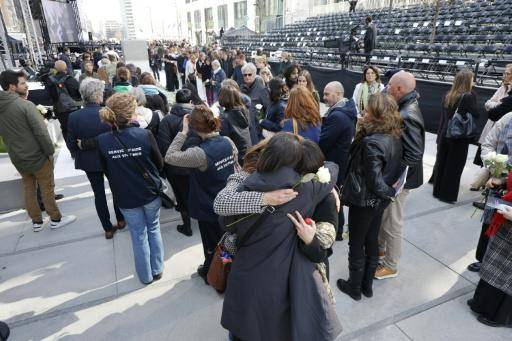 Los asistentes se abrazan durante una ceremonia de conmemoración de los atentados terroristas de marzo de 2016 en el monumento conmemorativo de la Rue de la Loi (Wetstraat) en Bruselas, el 22 de marzo de 2026