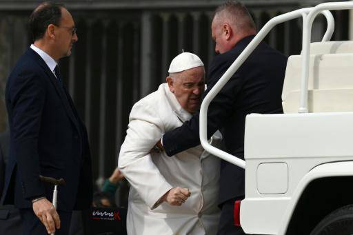 Un asistente ayuda al papa Francisco a subir al vehículo popularmente conocido como 'papamóvil' al término de la audiencia general semanal, el 29 de marzo de 2023 en la plaza de San Pedro del Vaticano