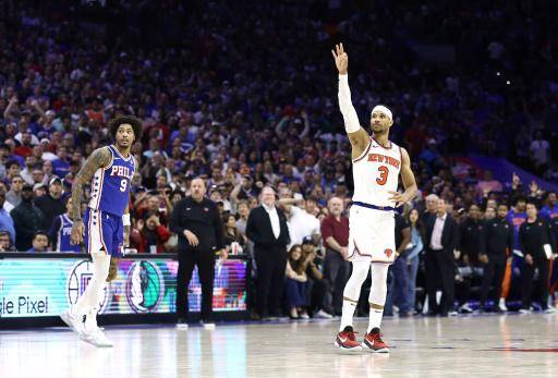 New York's Josh Hart celebrates his late three-pointer as Philadelphia's Kelly Oubre looks on in the Knicks' series-clinching victory over the 76ers in game six of their NBA Eastern Conference first round playoff series