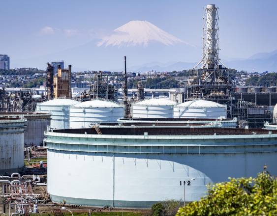 Tanques de almacenamiento en una refinería de petróleo mientras el monte Fuji se alza en el fondo, en Yokohama, prefectura de Kanagawa.