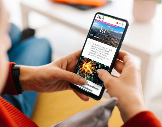 Unrecognizable young woman holding a mobile phone with white screen at home - Mockup for advertisement