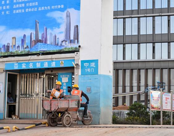 Construction workers are seen at the site of the new headquarters of the China Rare Earth Group in Ganzhou, in eastern China's Jiangxi province on November 21, 2025. China's stranglehold on the rare earths industry -- from natural reserves and mining through processing and innovation -- is the result of a decades-long drive, now giving Beijing crucial leverage in its trade war with the United States. (Photo by Hector RETAMAL / AFP) / TO GO WITH AFP STORY CHINA-US-TECHNOLOGY-DIPLOMACY-MINING, YEARENDER BY PETER CATTERALL