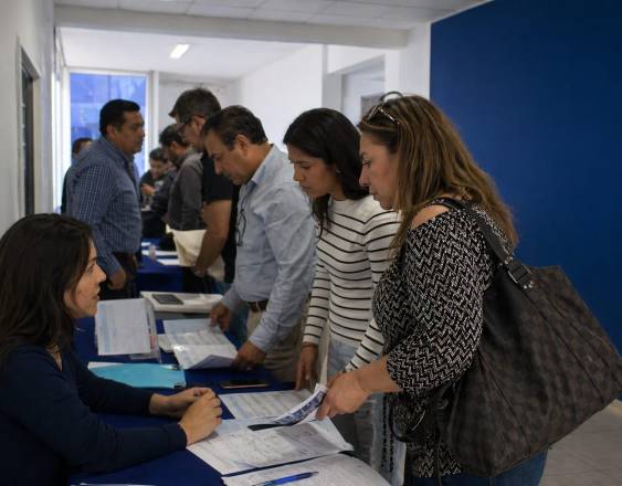 Inteligencia Artificial | Personas haciendo fila en una oficina para inscripciones.