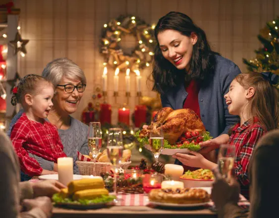 ML | Una familia con su cena en fiestas de fin de año comiendo pavo.