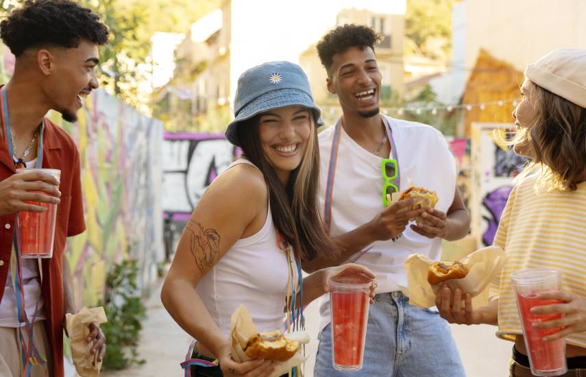 Freepik | Jóvenes adultos comiendo durante una fiesta que realizaron en el barrio.