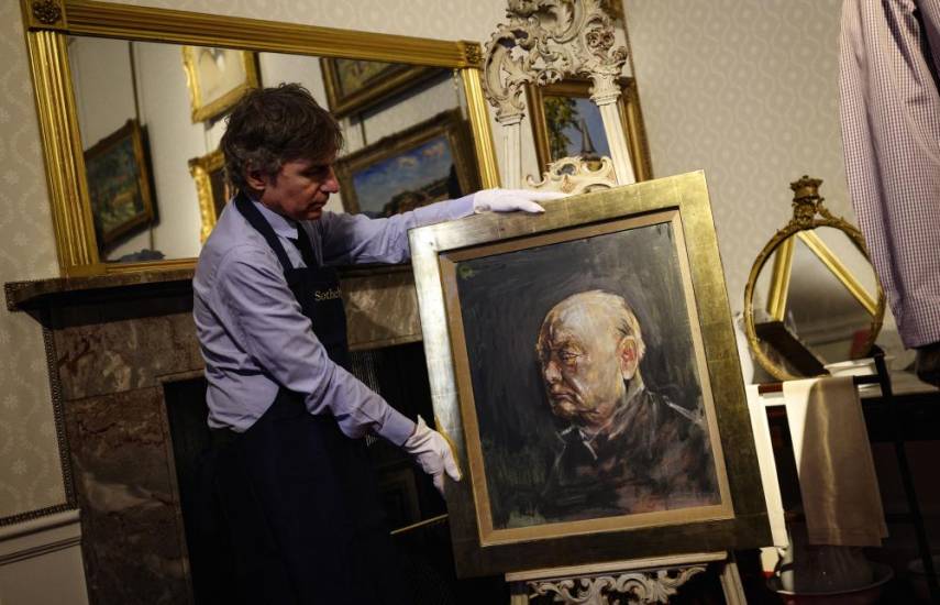 AFP | Matthew Floris, empleado de Sotheby's junto al retrato.