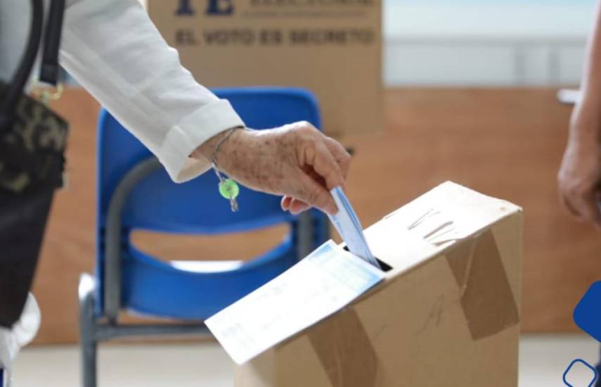 ML | Una persona introduciendo su voto en una urna.